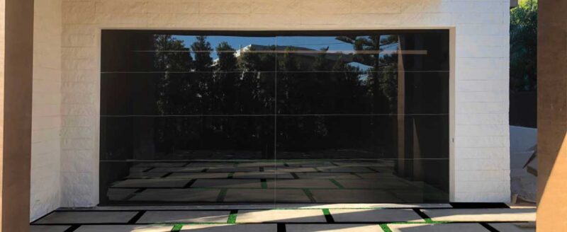 Frameless glass garage door