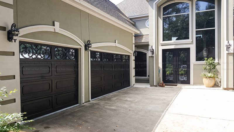 Large gray home with iron doors