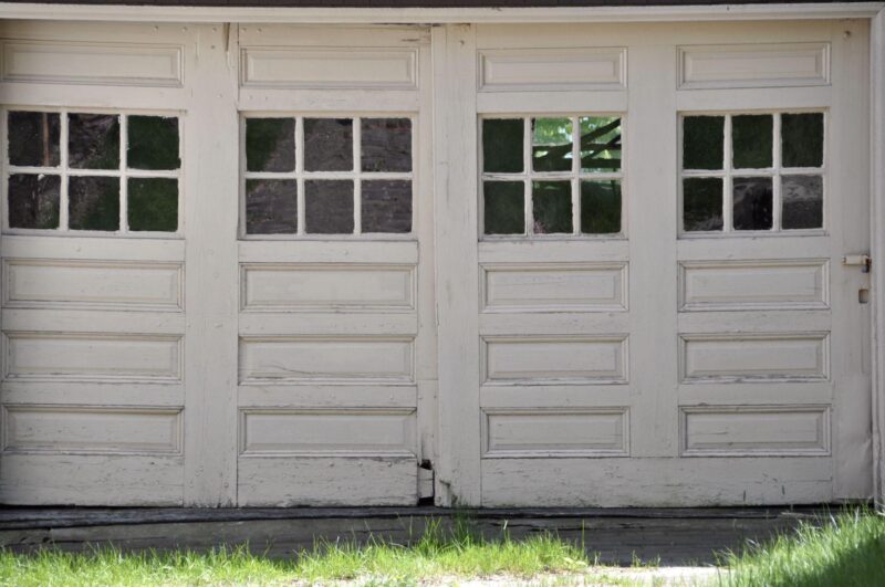White wood car damaged garage door