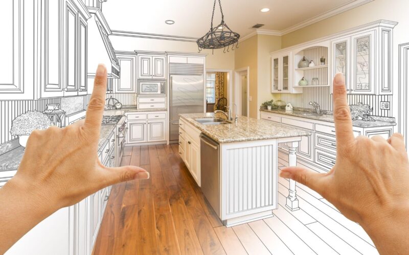 Female hands framing custom kitchen design drawing and photo combination.