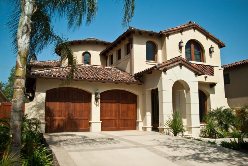 Stained wood custom garage doors for large home