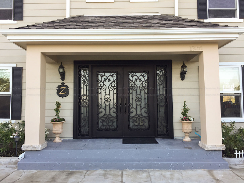 Custom wrought iron door from Precise Iron Doors on a barndominium