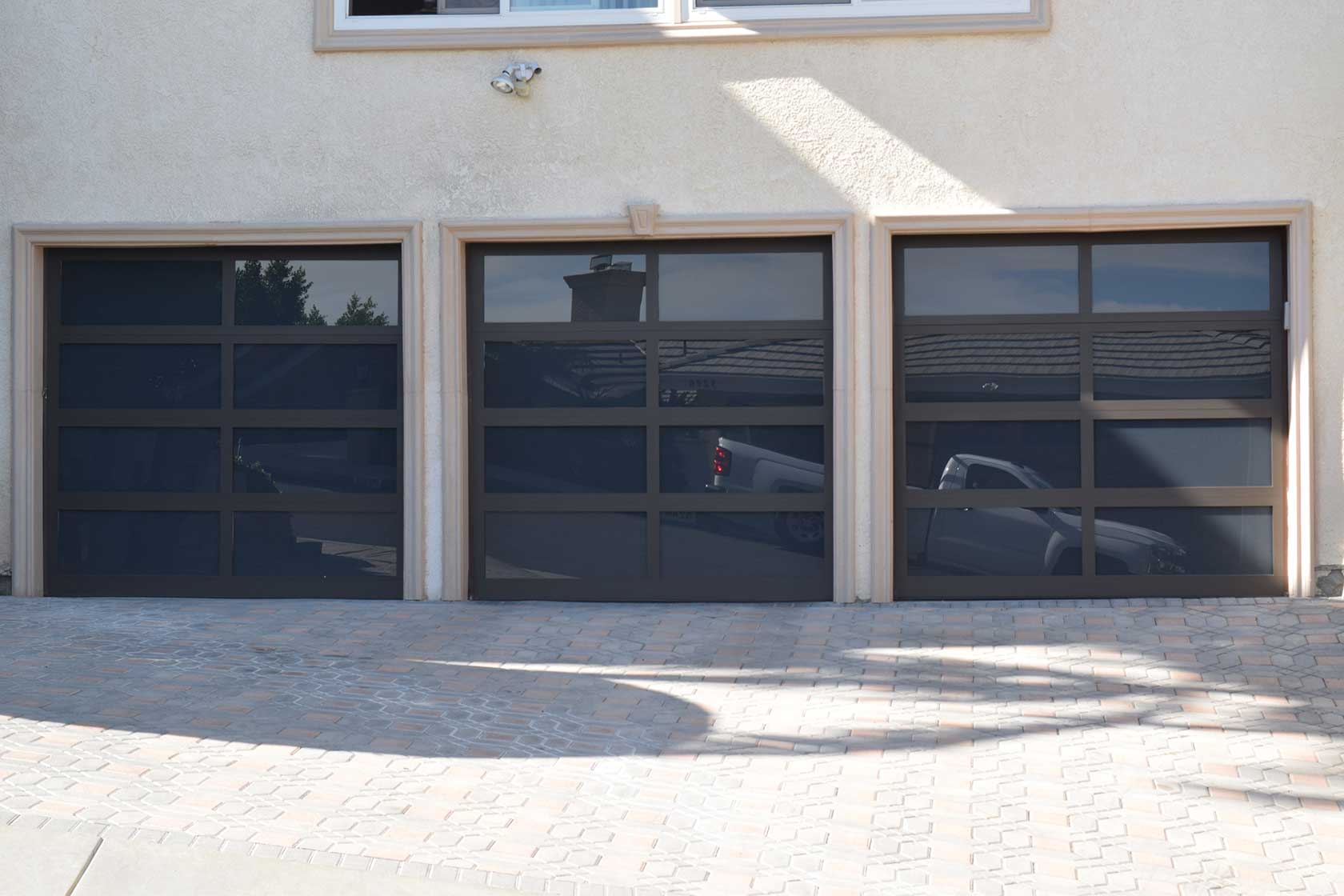 Three aluminum glass garage doors from Precise Iron Doors